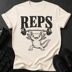 Cream t-shirt with black text "REPS" and an axolotl lifting a barbell.