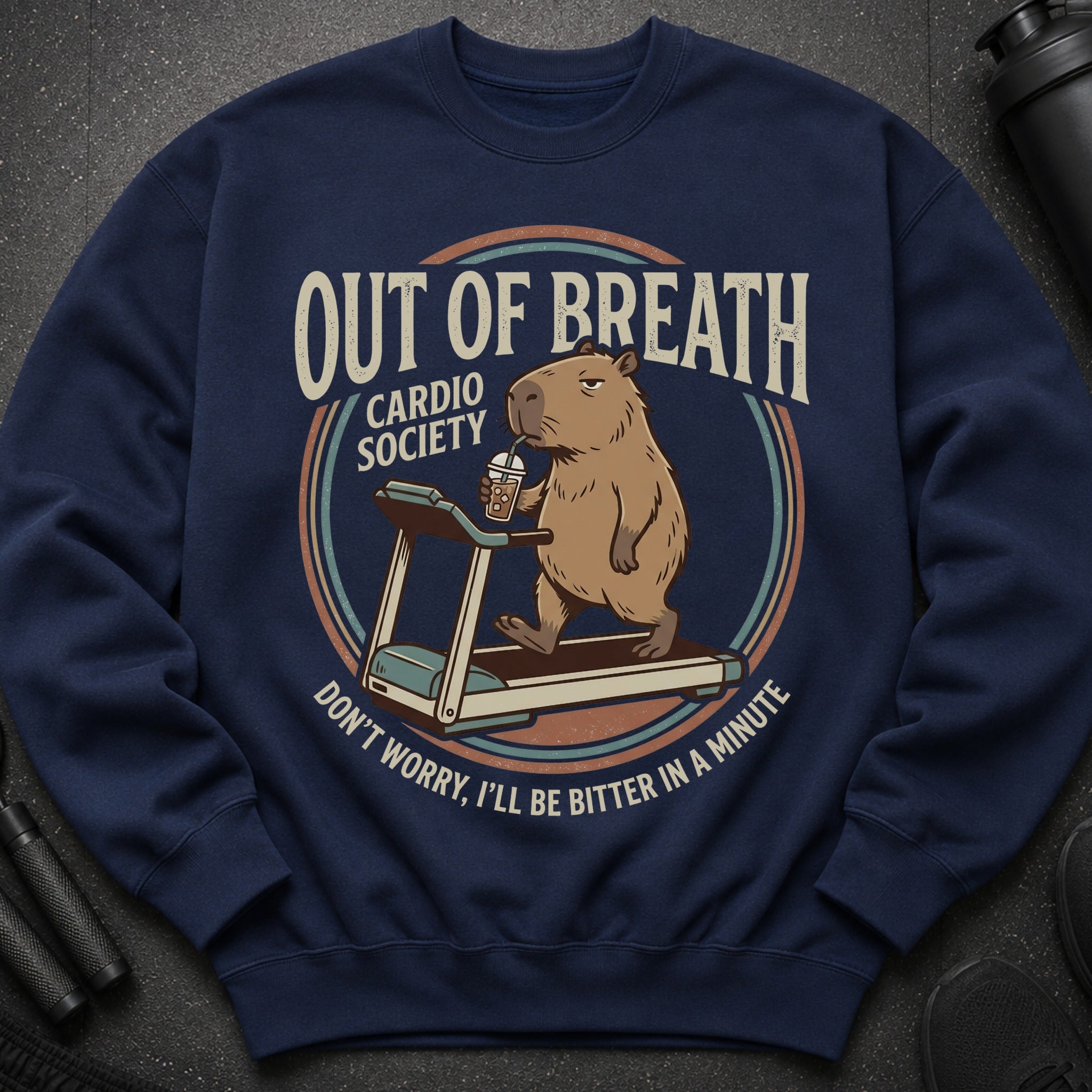 Navy sweatshirt with a capybara on a treadmill drinking coffee, text reads "Out of Breath Cardio Society".