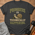 Dark gray t-shirt with a snail lifting a dumbbell and text "PROGRESS IS TECHNICALLY HAPPENING."