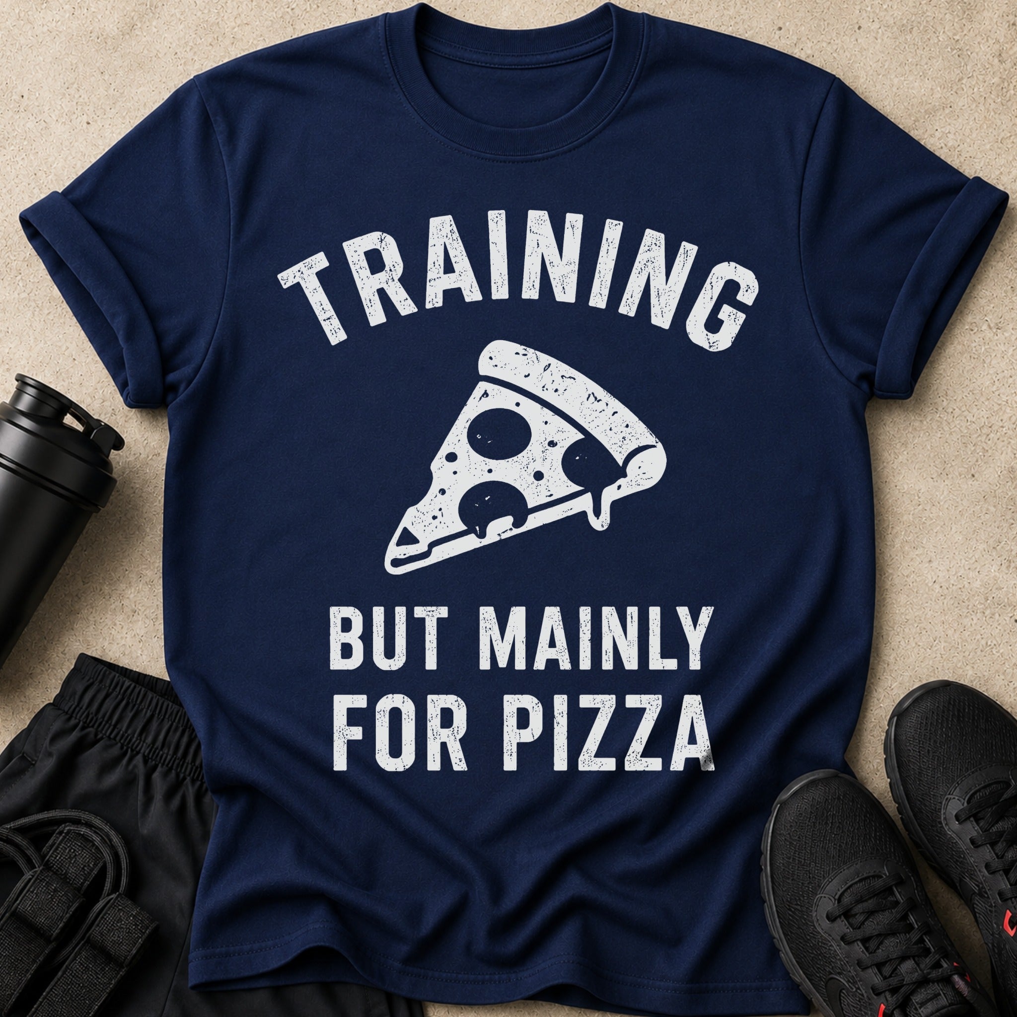 Navy t-shirt with "TRAINING BUT MAINLY FOR PIZZA" text and a pizza slice graphic.