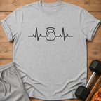Grey t-shirt with black kettlebell heartbeat graphic and rolled sleeves.