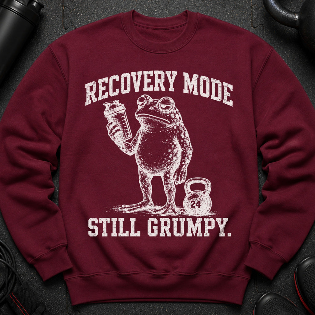 Maroon sweatshirt with distressed print of a grumpy frog holding a shaker and a kettlebell labeled 24.