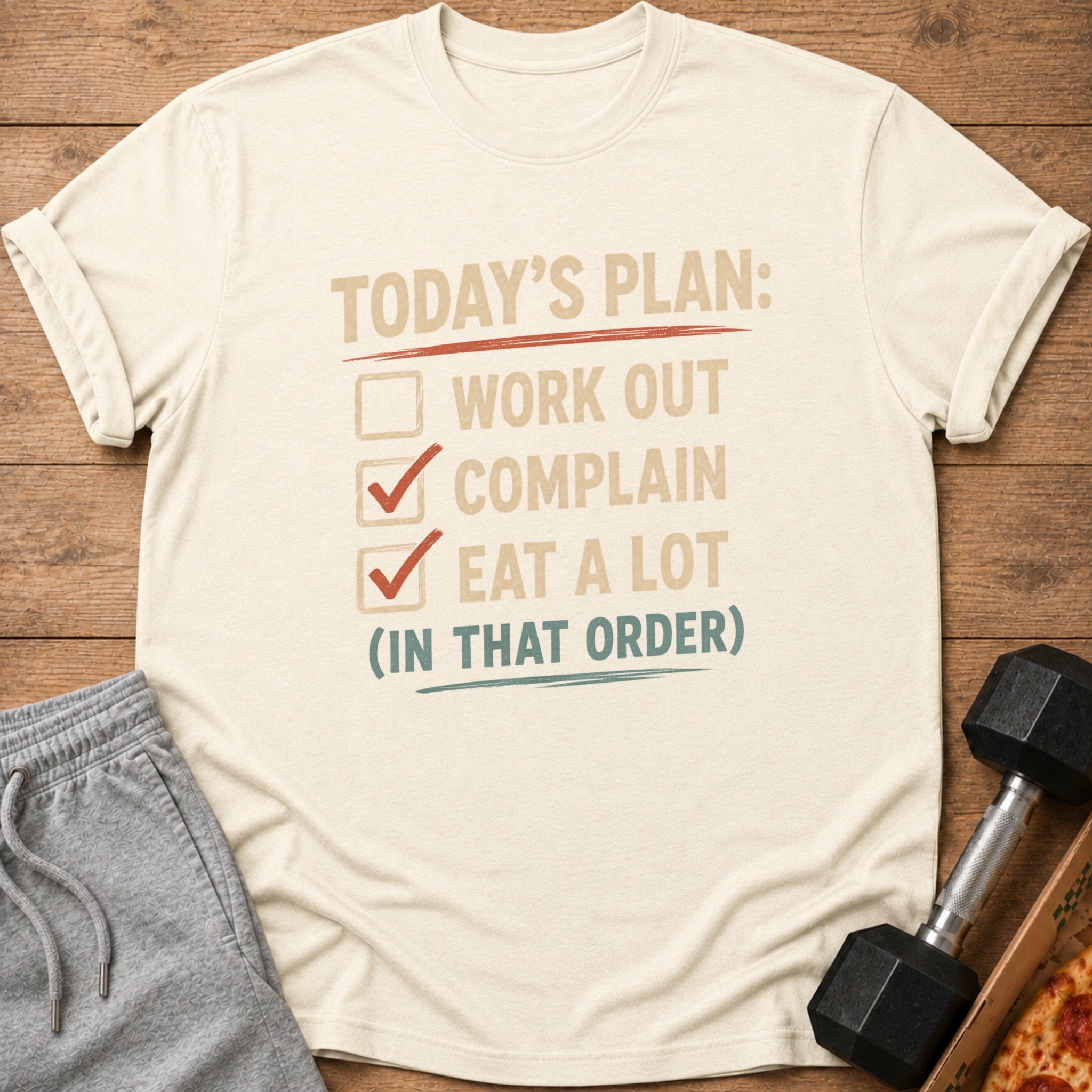 Light cream t-shirt with text "Today's plan: Work out, complain, eat a lot (in that order)".