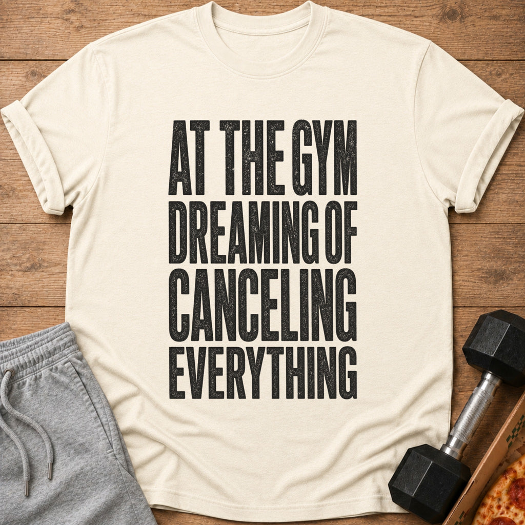 Cream t-shirt with black text "At the Gym Dreaming of Canceling Everything."