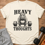 T-shirt with a vintage-style hippo lifting a barbell, text reads "HEAVY THOUGHTS".