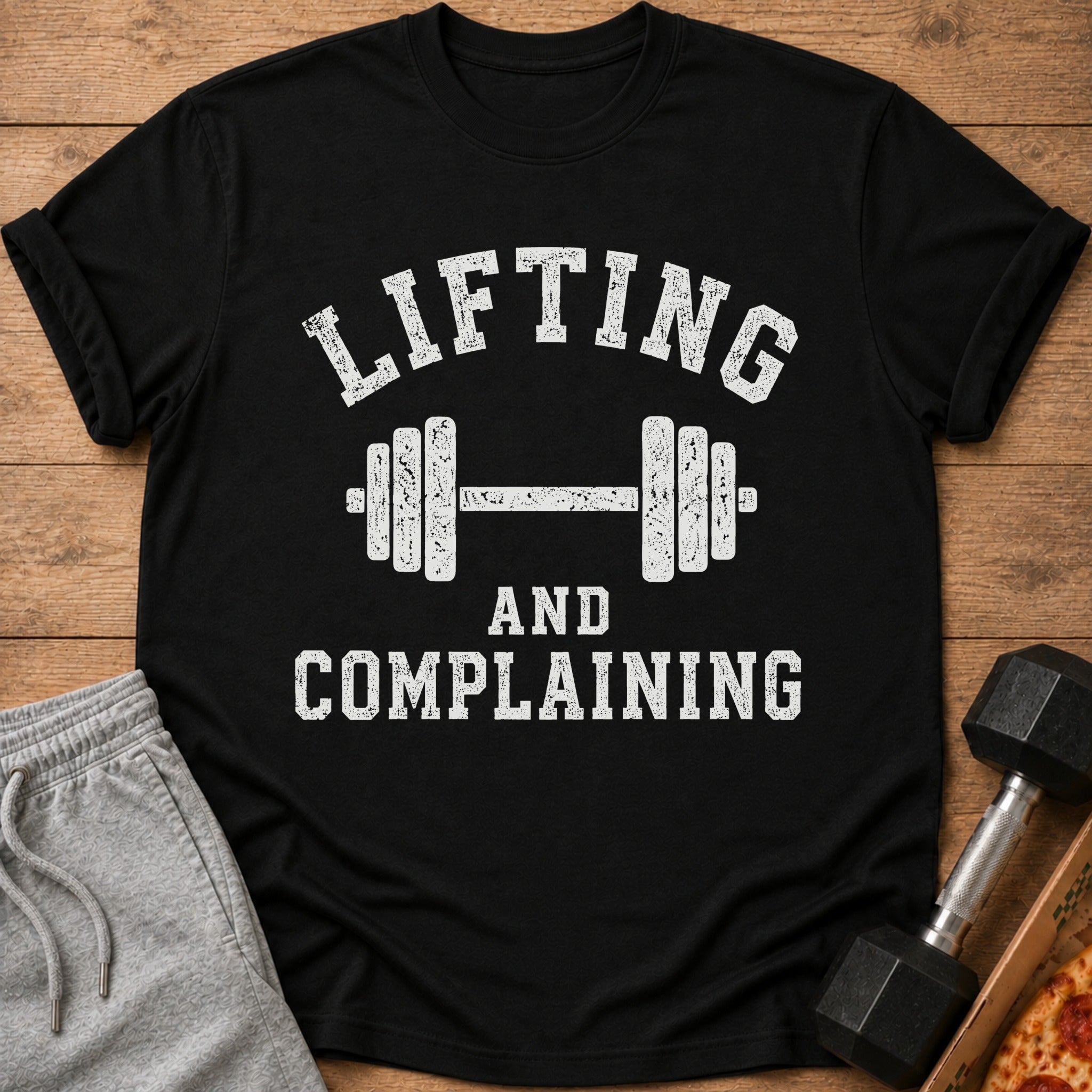 Black t-shirt with white text "Lifting and Complaining" and dumbbell graphic.