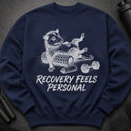 Navy sweatshirt with a raccoon exercising and text "Recovery Feels Personal".