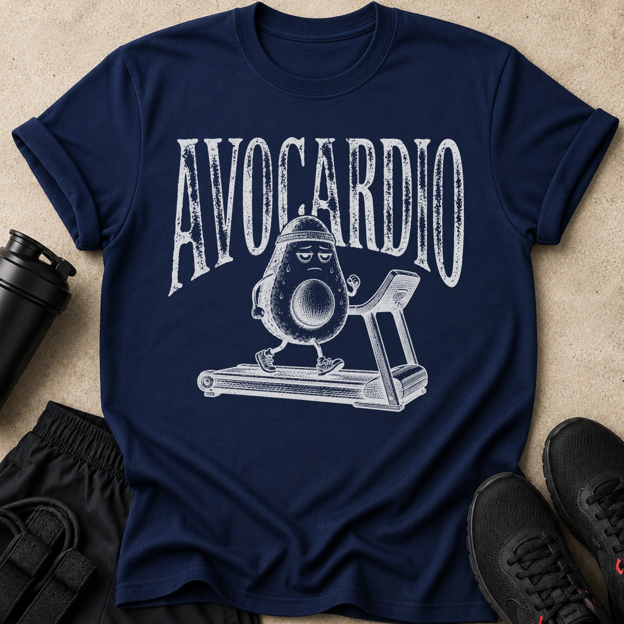 Navy t-shirt with distressed text "AVOCARDIO" and a cartoon avocado running on a treadmill.