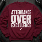 Maroon sweatshirt with white distressed text "ATTENDANCE OVER EXCELLENCE" and a checkmark.