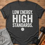 Dark grey t-shirt with "LOW ENERGY. HIGH STANDARDS." text and a weight plate graphic.