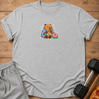 Gray t-shirt with a cartoon capybara holding a dumbbell and a donut.