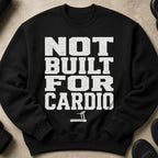 Black crewneck sweatshirt with distressed white text "NOT BUILT FOR CARDIO" and treadmill graphic.