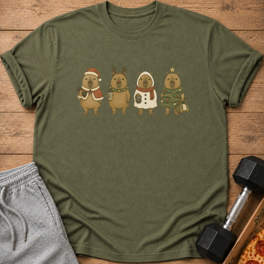 Green t-shirt with four capybaras in festive holiday costumes: Santa, reindeer, snowman, and Christmas tree.