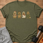 Green t-shirt with four capybaras in festive holiday costumes: Santa, reindeer, snowman, and Christmas tree.