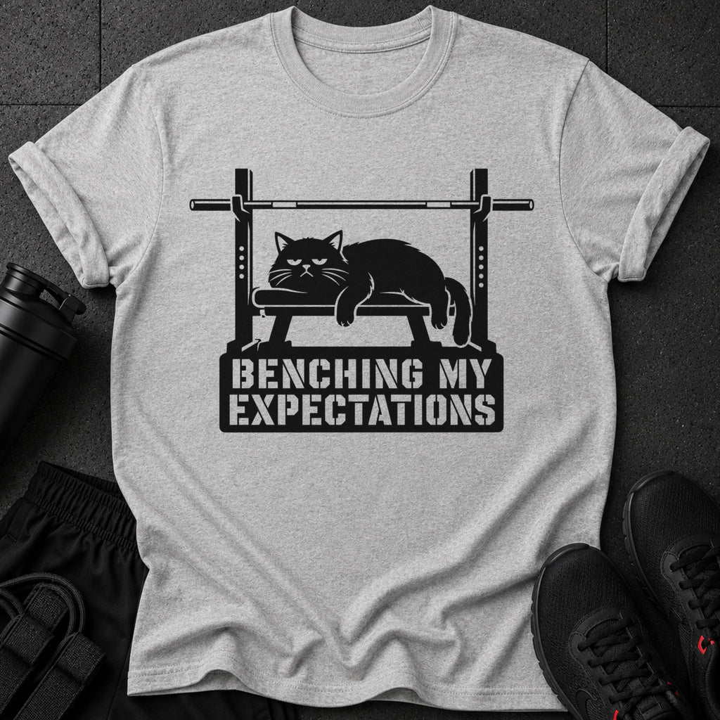 Light grey t-shirt with black graphic of cat on weight bench and text.