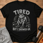 Black t-shirt with tired frog graphic, text "TIRED BUT I SHOWED UP."