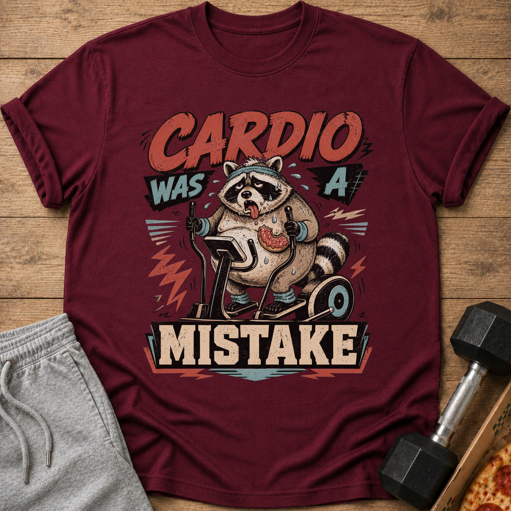 Maroon t-shirt with a raccoon on an elliptical saying "Cardio Was A Mistake".