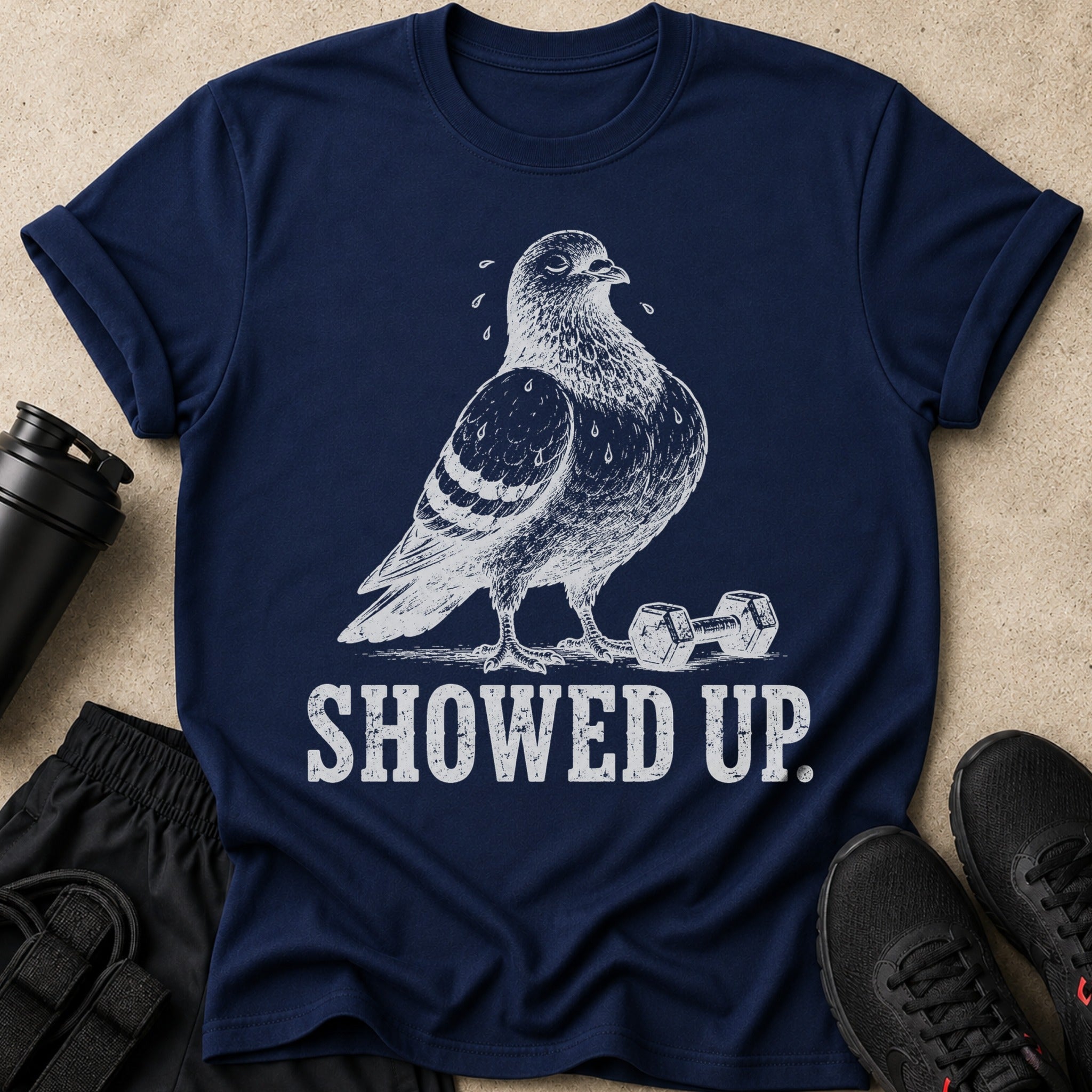 Navy t-shirt with white graphic of a pigeon, dumbbell, and text "SHOWED UP."
