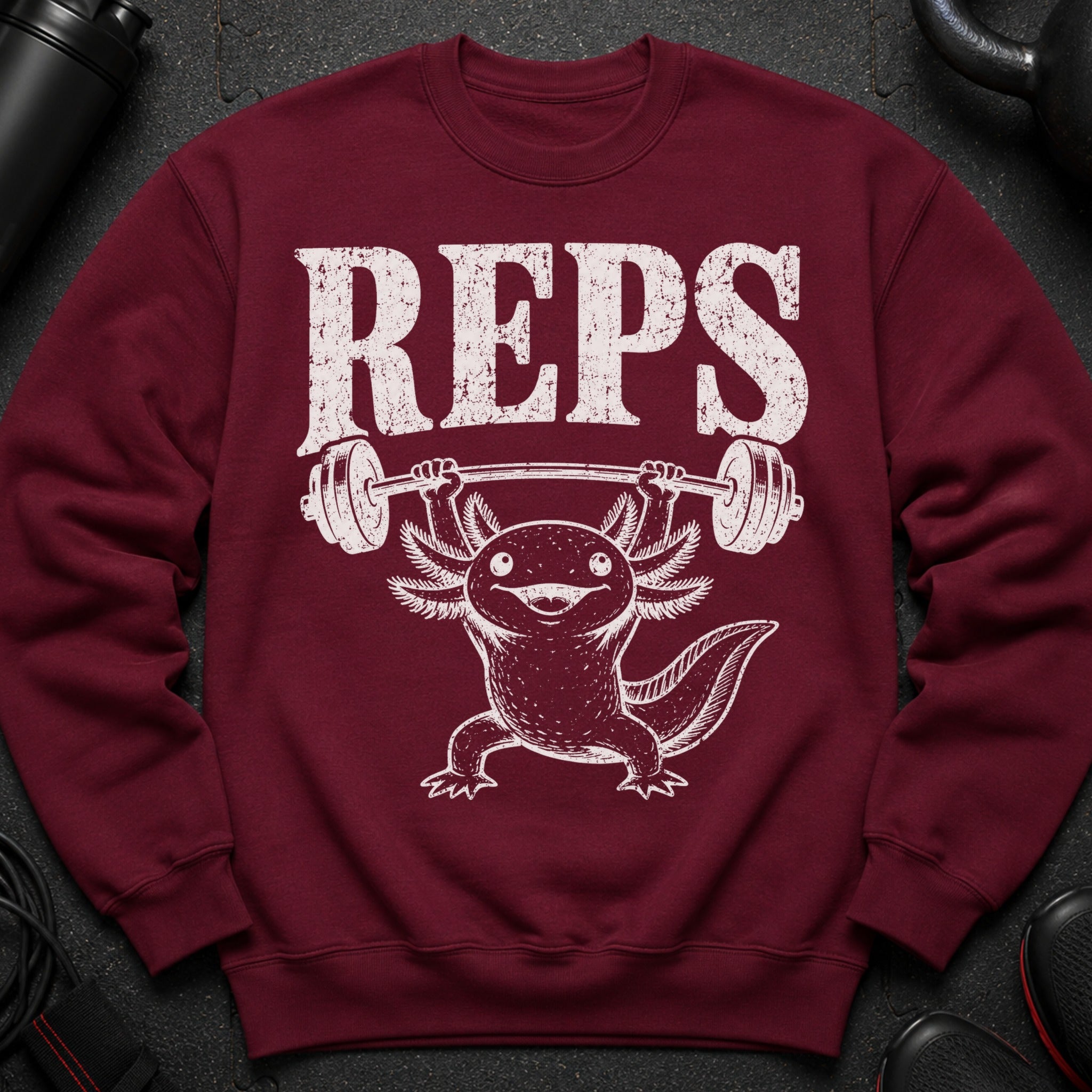 Maroon sweatshirt with white "REPS" text and an axolotl lifting a barbell.
