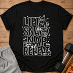 Black t-shirt with white text "Lift Snack Nap Repeat" and cartoon graphics.
