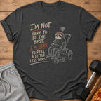 Dark t-shirt with sloth at gym and text "I'm not here to be the best. I'm here to feel a little less worst."