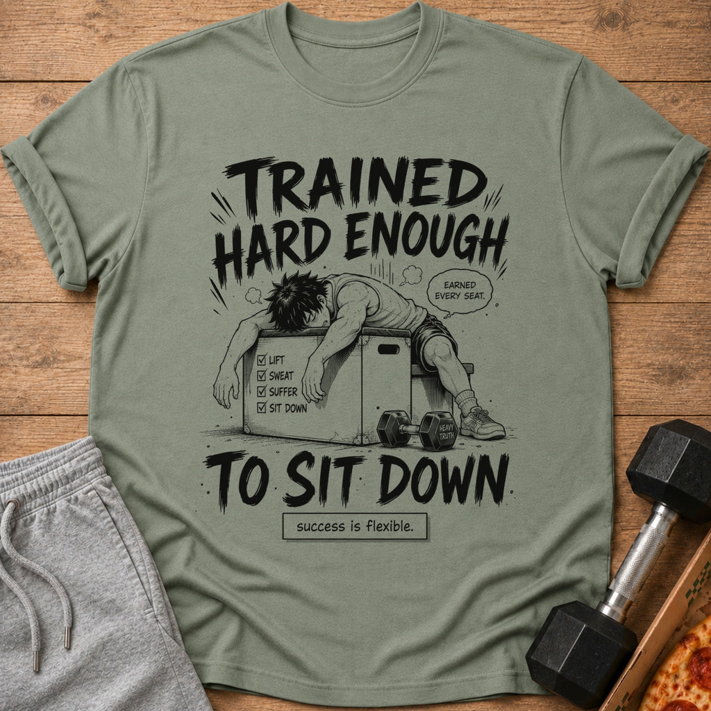 Green t-shirt with illustration of exhausted person, text "TRAINED HARD ENOUGH TO SIT DOWN".
