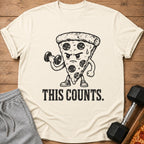 Cream t-shirt with cartoon pepperoni pizza lifting dumbbell and text "THIS COUNTS."