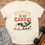 T-shirt with "Resting Is My Cardio" text and illustration of person resting on bench.