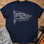 Navy t-shirt with "Overstimulated Mom Still Lifting Club" graphic.