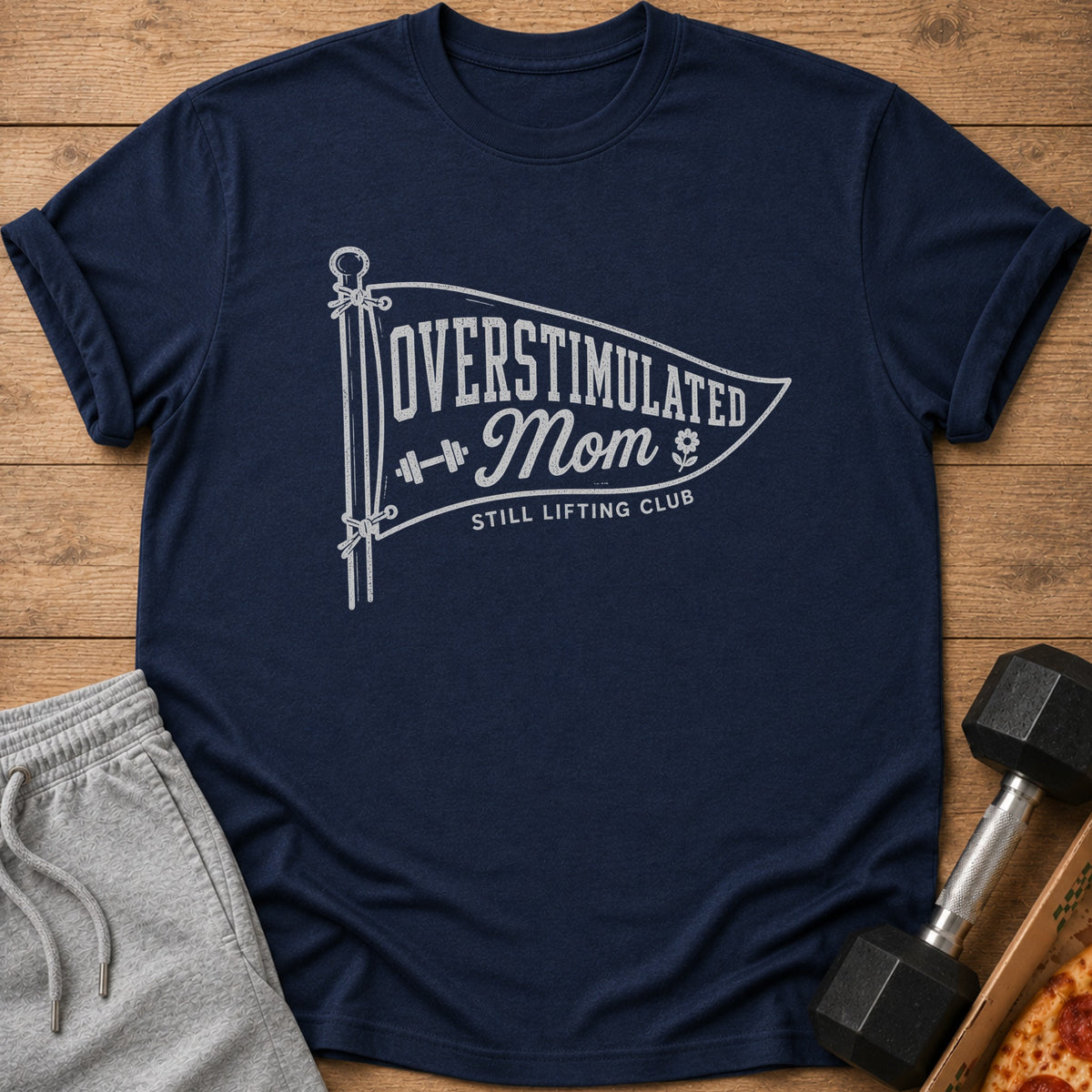Navy t-shirt with "Overstimulated Mom Still Lifting Club" graphic.