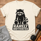 Graphic of a raccoon holding kettlebells with text "RARELY MOTIVATED".
