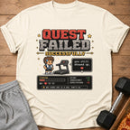 Pixelated t-shirt graphic: "QUEST FAILED SUCCESSFULLY" with stats and a treadmill.
