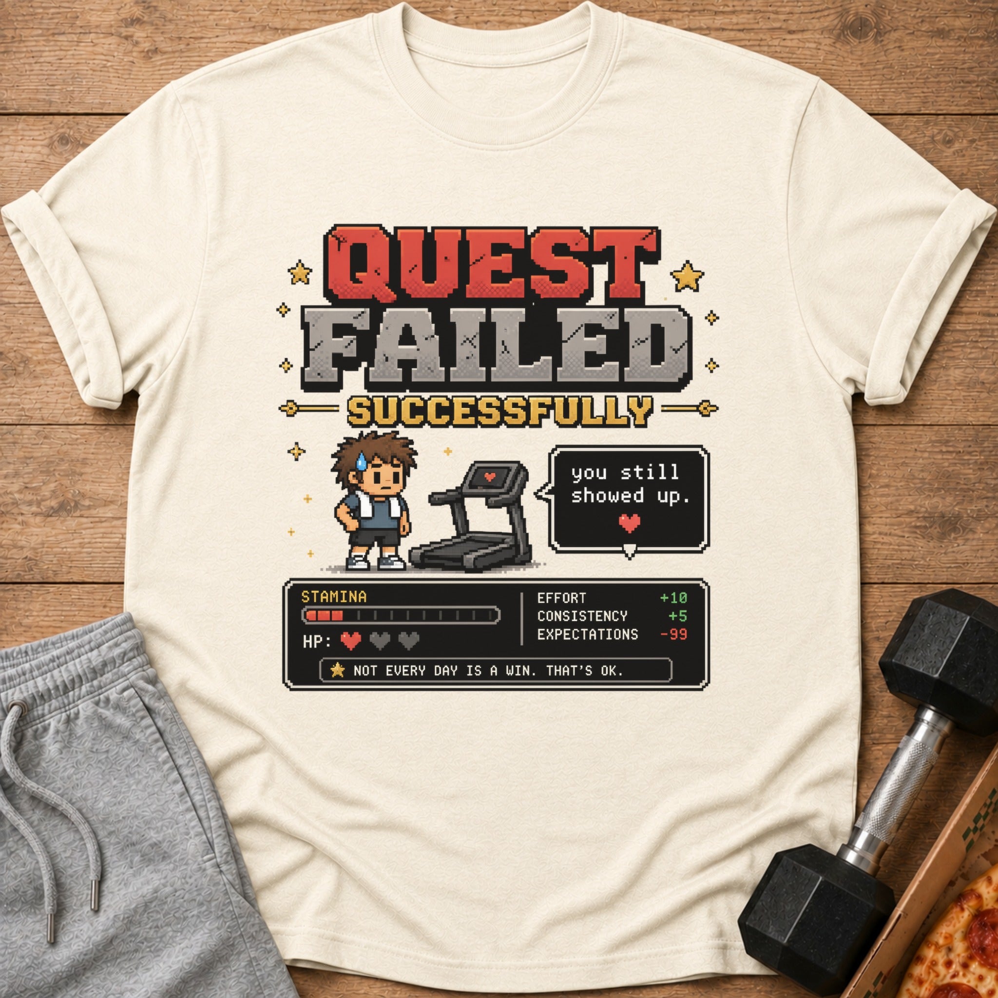 Pixelated t-shirt graphic: "QUEST FAILED SUCCESSFULLY" with stats and a treadmill.