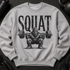 Grey sweatshirt with distressed "SQUAT" text above a Bigfoot lifting a barbell.