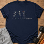 T-shirt with a graphic of four skeletons engaged in different activities.