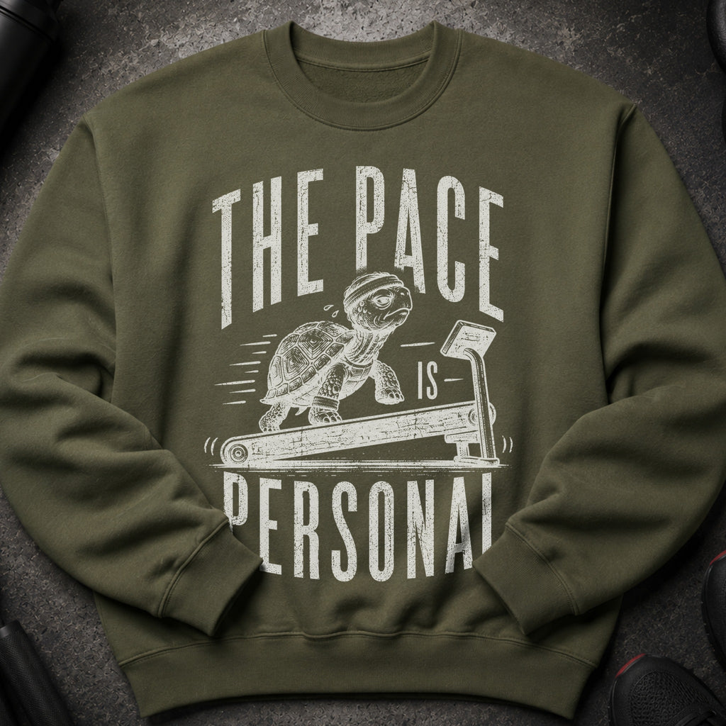 Green sweatshirt with a graphic of a tortoise on a treadmill, reading "The Pace is Personal".