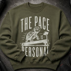 Green sweatshirt with a graphic of a tortoise on a treadmill, reading "The Pace is Personal".