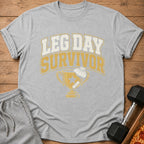 Grey t-shirt with "Leg Day Survivor" text and trophy graphic.