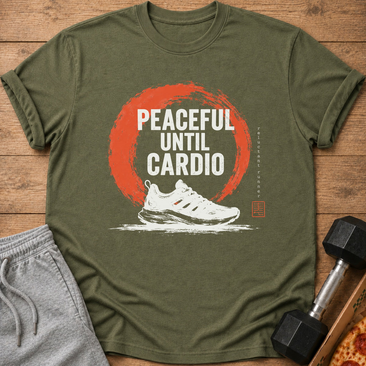 Olive green t-shirt with "PEACEFUL UNTIL CARDIO" text, a running shoe, and a dumbbell.