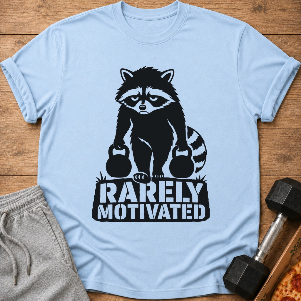 Light blue t-shirt with black graphic of raccoon holding weights and text "RARELY MOTIVATED".