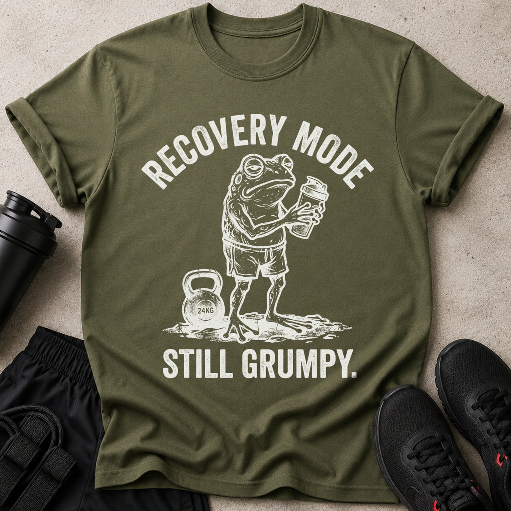 Olive green t-shirt with a distressed graphic of a grumpy frog holding a shaker bottle and the text "Recovery Mode Still Grumpy."