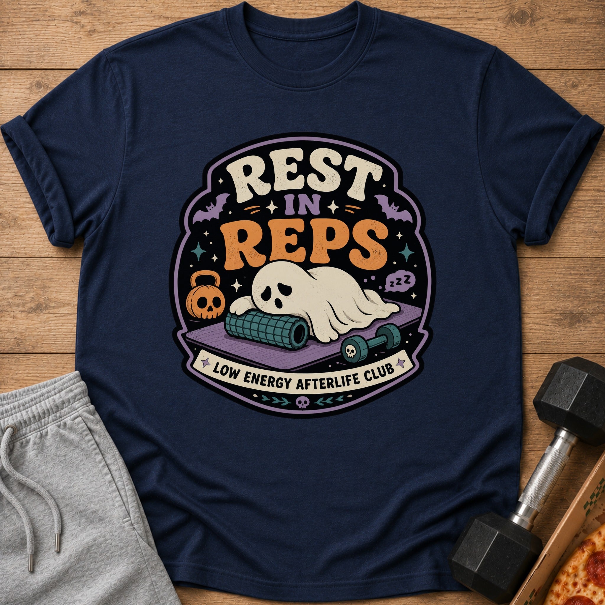 T-shirt graphic with ghost, gym equipment, and text "REST IN REPS LOW ENERGY AFTERLIFE CLUB."