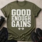 Green t-shirt with white text "GOOD ENOUGH GAINS" and barbell graphic.