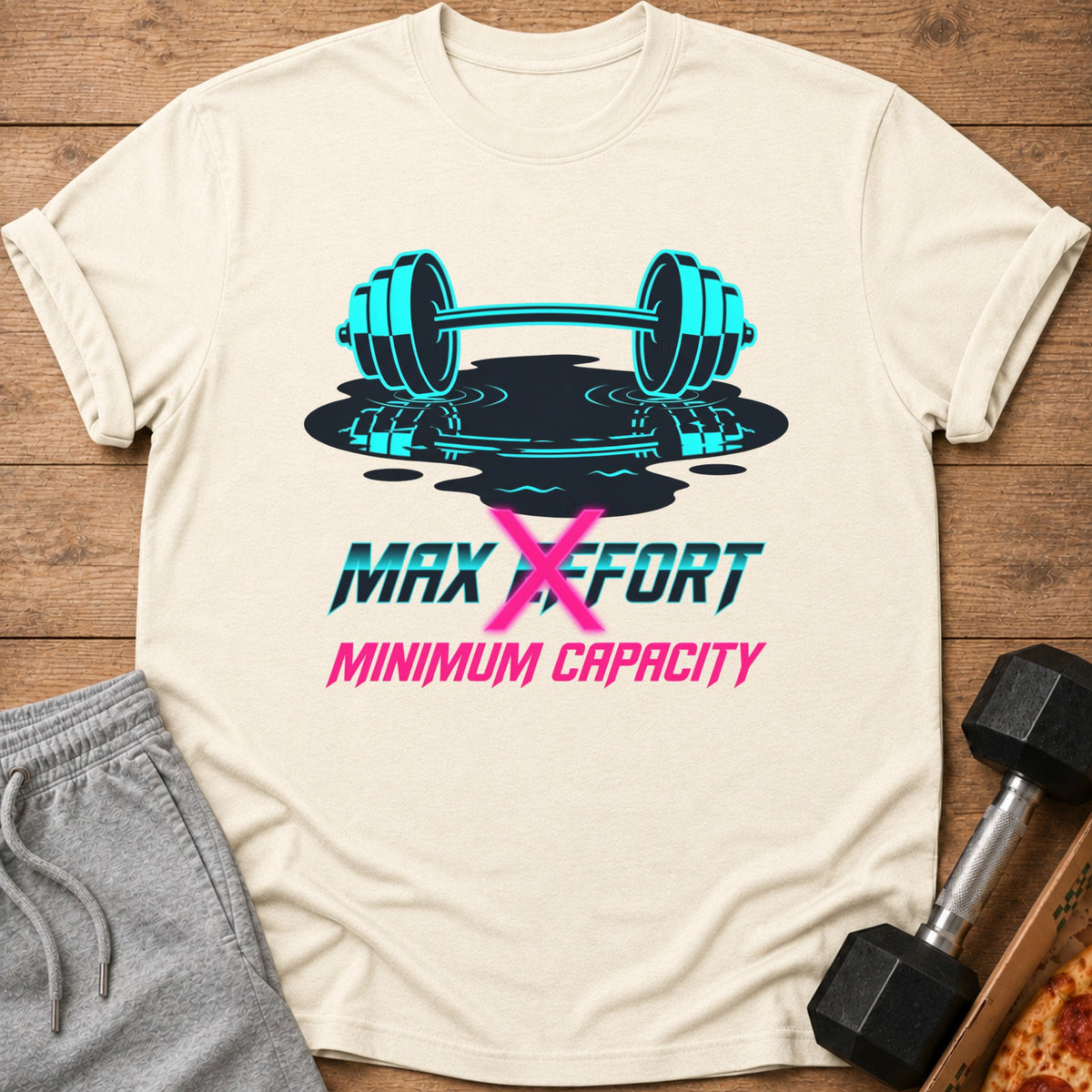 Light cream t-shirt with graphic of turquoise barbell and text "MAX EFFORT MINIMUM CAPACITY".