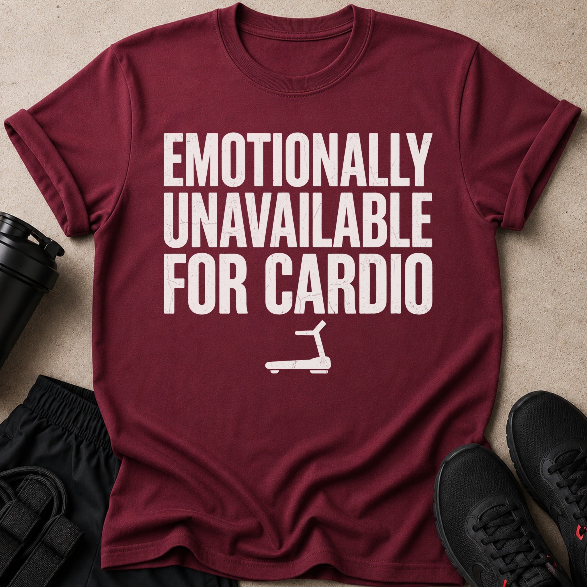 Maroon t-shirt with white text "EMOTIONALLY UNAVAILABLE FOR CARDIO" and treadmill graphic.