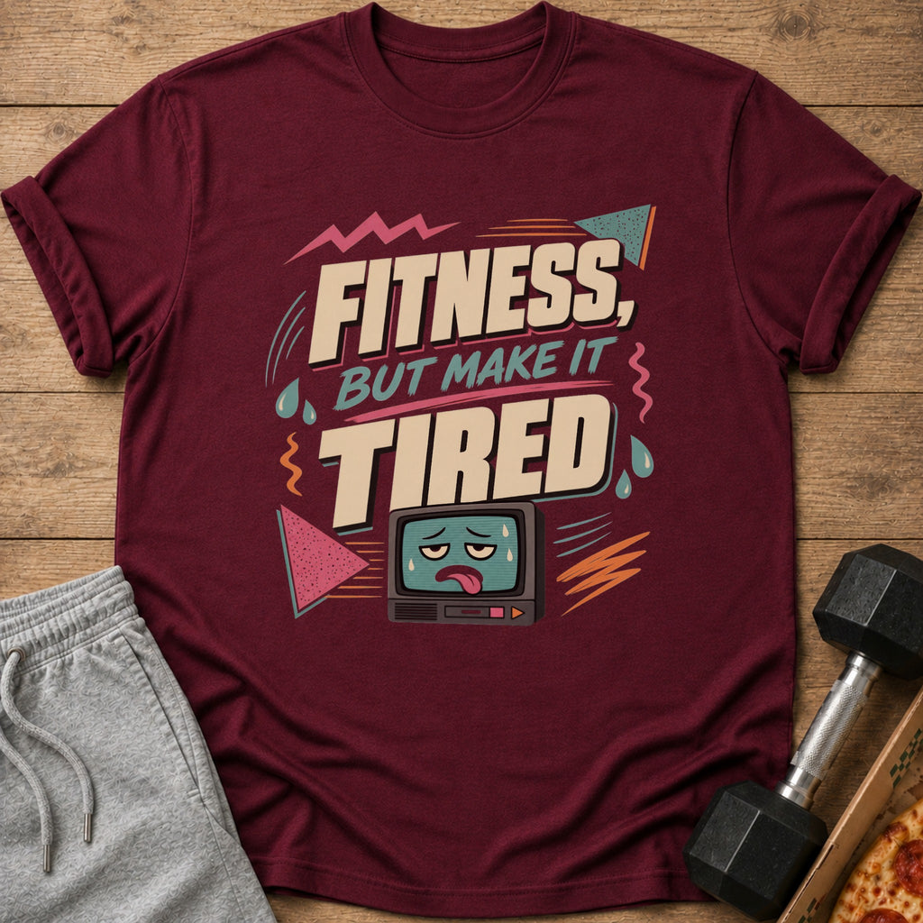 Maroon t-shirt with text "Fitness, But Make It Tired" and a tired television graphic.