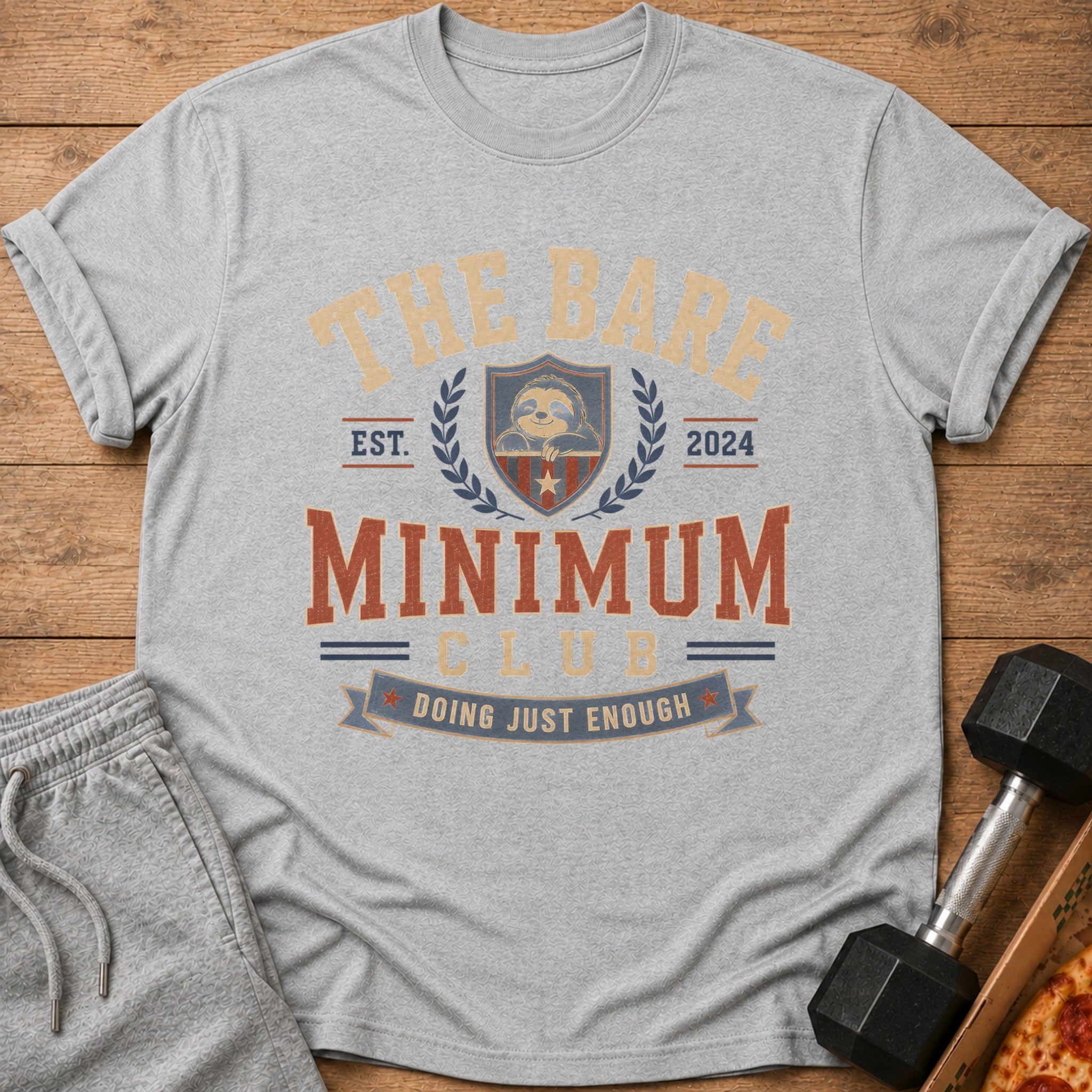 Grey t-shirt with "The Bare Minimum Club Doing Just Enough" text and sloth graphic.