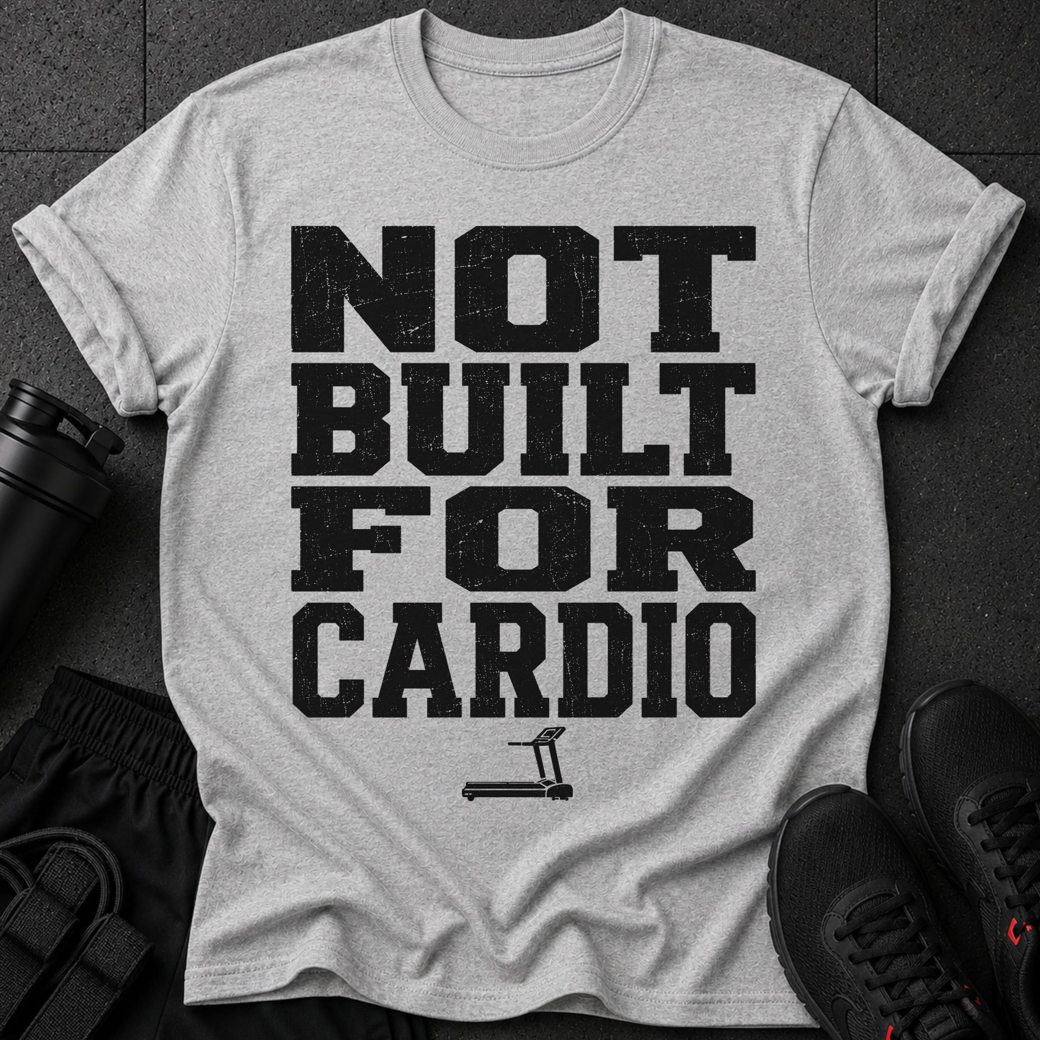 Grey t-shirt with black text "NOT BUILT FOR CARDIO" and a treadmill icon.