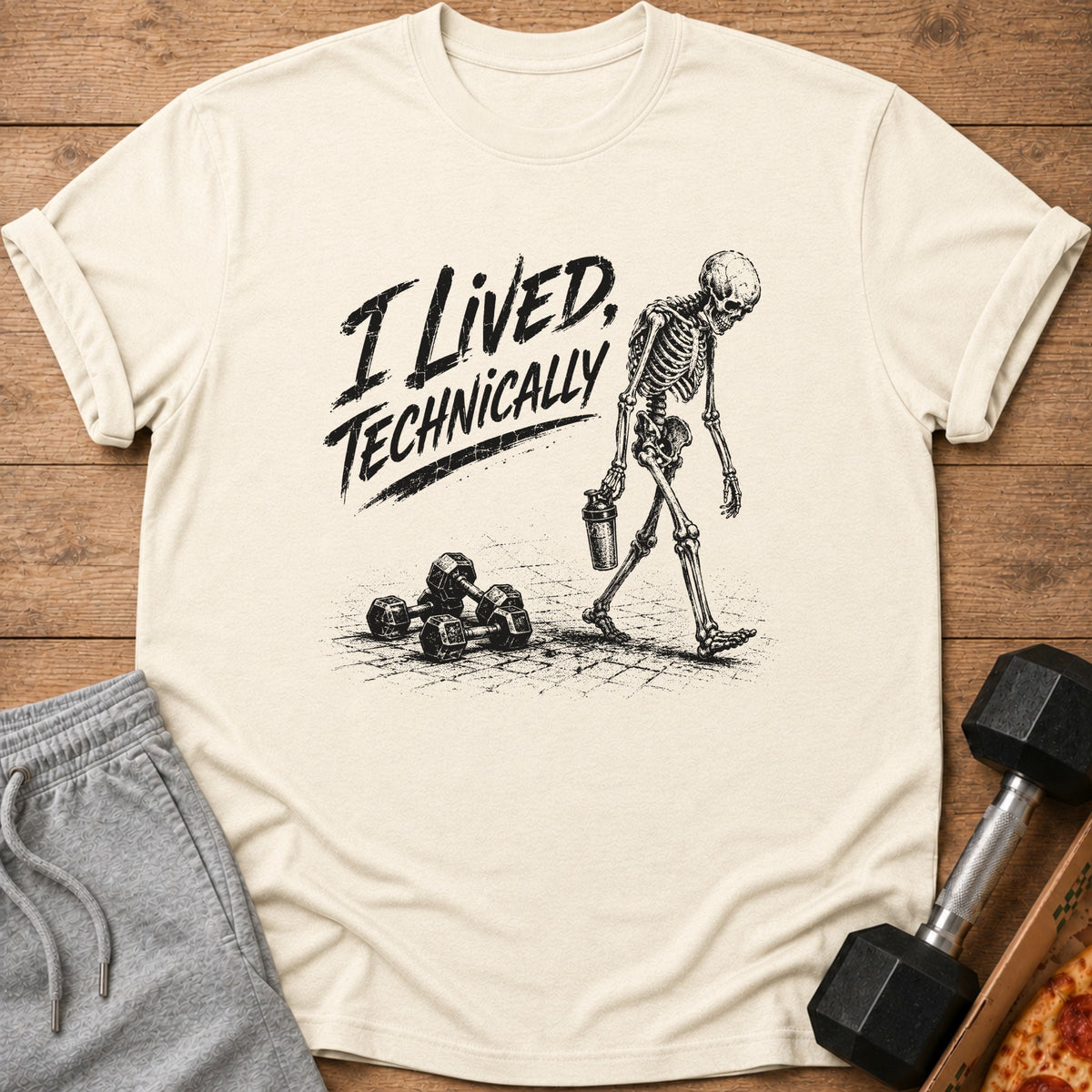Skeleton with dumbbells and shaker on a shirt that says "I Lived, Technically".
