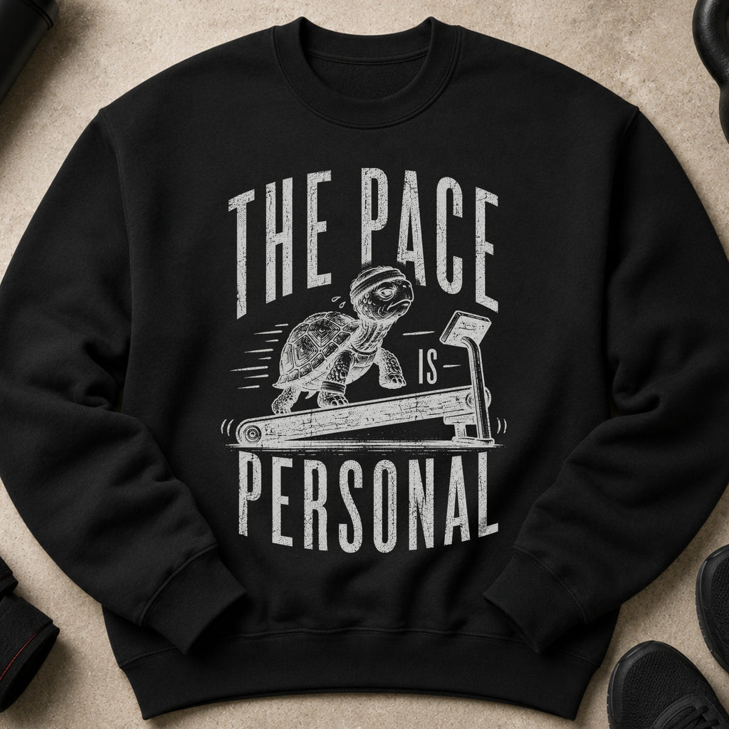 Black sweatshirt with distressed graphic of a turtle on a treadmill, reading "The Pace Is Personal".
